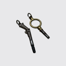 Load image into Gallery viewer, Two Antique Watch Key Pendants, including a Pistol