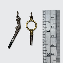Load image into Gallery viewer, Two Antique Watch Key Pendants, including a Pistol