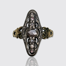 Load image into Gallery viewer, An antique Victorian mourning ring featuring a central rose-cut diamond surrounded by smaller diamonds, set in a silver-toned metal with gold-toned side bands, shown on a light gray background with a reflection below.